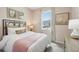 Comfortable bedroom filled with natural light, has a queen bed and complementing decor at 1355 Wood Line Loop, Deland, FL 32720