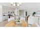 Open-concept dining area and kitchen with granite countertops, stainless steel appliances, and ample seating at 1355 Wood Line Loop, Deland, FL 32720