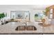 Modern kitchen island with granite countertops, stainless steel sink, and open view to the living area at 1355 Wood Line Loop, Deland, FL 32720