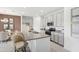 Modern kitchen with gray cabinets, granite countertops, stainless steel appliances, and breakfast bar at 1355 Wood Line Loop, Deland, FL 32720
