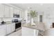 Well-lit kitchen featuring gray cabinets, stainless steel appliances, and a granite countertop island at 1355 Wood Line Loop, Deland, FL 32720