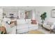 Inviting living area featuring a sectional sofa, accent chair, and kitchen view at 1355 Wood Line Loop, Deland, FL 32720