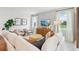 Bright living room featuring a large sectional sofa, accent chairs, and shiplap wall at 1355 Wood Line Loop, Deland, FL 32720