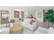 Open-concept living area with a large sectional sofa, kitchen in the background, and neutral decor at 1355 Wood Line Loop, Deland, FL 32720
