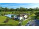 Aerial view of a community pool area with a pool house, playground, and parking lot at 1355 Wood Line Loop, Deland, FL 32720