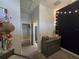 Neutral bedroom featuring a gray dresser, string lights, and an adjoining bathroom at 14641 Henson Rd, Orlando, FL 32832