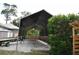 View of open metal carport with gravel flooring next to landscaping and building at 14641 Henson Rd, Orlando, FL 32832