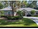 Charming single-story home with meticulously landscaped front yard, mature trees, and welcoming curb appeal at 14641 Henson Rd, Orlando, FL 32832