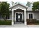 Inviting front entry with decorative glass door, sidelights and manicured shrubbery at 14641 Henson Rd, Orlando, FL 32832
