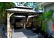 A shaded gazebo with a swing and chairs sits on a stone patio with a privacy fence at 14641 Henson Rd, Orlando, FL 32832
