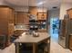 Well-appointed kitchen with stainless steel appliances, center island, and ample cabinet space at 14641 Henson Rd, Orlando, FL 32832