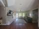 Open concept living room features wood flooring, a stone fireplace and an abundance of light at 14641 Henson Rd, Orlando, FL 32832