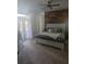Light-filled bedroom with wood accent wall, plush carpet and direct access to the backyard at 14641 Henson Rd, Orlando, FL 32832