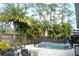 A beautiful in-ground pool with patio, fire pit and fence on a well-landscaped lot at 14641 Henson Rd, Orlando, FL 32832