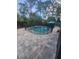 Backyard swimming pool and spa enclosed by a safety fence and surrounded by a paved patio area at 14641 Henson Rd, Orlando, FL 32832