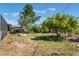 The backyard is landscaped with an enclosed patio, a fire pit, and a canopy from a mature fruit tree at 1510 Chatsworth Ave, Deltona, FL 32738