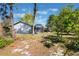 Spacious backyard featuring a fenced perimeter, screen enclosed patio, and shaded areas from mature trees at 1510 Chatsworth Ave, Deltona, FL 32738