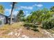 Picturesque backyard with a screen enclosed patio, mature trees and ample green space on a sunny day at 1510 Chatsworth Ave, Deltona, FL 32738
