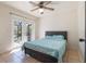 This bedroom has plenty of natural light with access to the back patio through glass doors at 1510 Chatsworth Ave, Deltona, FL 32738