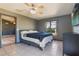Bedroom with ceiling fan, tile floors and a view of tropical trees outside the window at 1510 Chatsworth Ave, Deltona, FL 32738