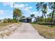 Street view of a cozy one story home featuring a long driveway and luscious yard at 1510 Chatsworth Ave, Deltona, FL 32738