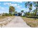 Street view of a cozy one story home featuring a long driveway and luscious yard at 1510 Chatsworth Ave, Deltona, FL 32738