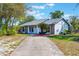 Cozy single-story home with a well-maintained lawn, lush landscaping, and a concrete driveway at 1510 Chatsworth Ave, Deltona, FL 32738