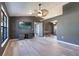 Bright living room with gray walls, modern ceiling fan, wood floors and a large window at 1510 Chatsworth Ave, Deltona, FL 32738