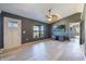 Inviting living room featuring gray walls, light wood floors, a modern ceiling fan, and a large window at 1510 Chatsworth Ave, Deltona, FL 32738