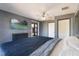 Spacious bedroom with light tile flooring, ceiling fan, dresser, and a view of the backyard at 1510 Chatsworth Ave, Deltona, FL 32738