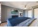 Bedroom featuring ceiling fan, tile floors, large bed, and sliding glass door to the backyard at 1510 Chatsworth Ave, Deltona, FL 32738