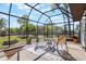 Bright screened patio featuring outdoor seating and view of the backyard at 1510 Chatsworth Ave, Deltona, FL 32738
