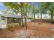 Expansive backyard with lush greenery, a cozy fire pit, and a screened porch, perfect for outdoor entertaining at 1514 Pelican St, Longwood, FL 32750