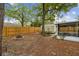 Serene backyard featuring mature trees, a convenient storage shed, and a cozy fire pit, perfect for outdoor enjoyment at 1514 Pelican St, Longwood, FL 32750