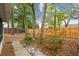 Secluded backyard featuring mature trees, a fire pit, and a privacy fence, offering a peaceful outdoor retreat at 1514 Pelican St, Longwood, FL 32750