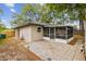 Charming backyard featuring a patio, screen porch, and privacy fence at 1514 Pelican St, Longwood, FL 32750