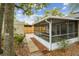 Cozy screened-in porch with peaceful backyard, mature tree and stone pathway at 1514 Pelican St, Longwood, FL 32750