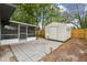Backyard showing screened porch, storage shed, dog, and partial fence at 1514 Pelican St, Longwood, FL 32750