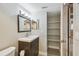 This bathroom has a dark wood cabinet and a matching framed mirror with open storage at 1514 Pelican St, Longwood, FL 32750