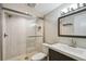 Modern bathroom featuring tiled shower with glass door and updated vanity at 1514 Pelican St, Longwood, FL 32750