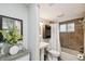 Bathroom featuring a dark cabinet, framed mirror, shower with tile, and flowers for decor at 1514 Pelican St, Longwood, FL 32750