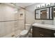 Updated bathroom featuring tiled shower with glass door and modern vanity at 1514 Pelican St, Longwood, FL 32750