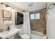 This bathroom features a tile shower with dark hardware and a white shower curtain at 1514 Pelican St, Longwood, FL 32750