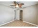 Neutral bedroom features a modern ceiling fan, closet, and light hardwood flooring at 1514 Pelican St, Longwood, FL 32750