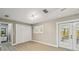 Bright bedroom with closet doors, a sunny window, and french doors to the patio at 1514 Pelican St, Longwood, FL 32750