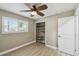 Bright bedroom with a stylish ceiling fan, natural light from the window, and closet storage at 1514 Pelican St, Longwood, FL 32750