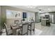 Open concept dining room with stylish table set and view to the kitchen at 1514 Pelican St, Longwood, FL 32750