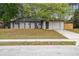 Charming single-story home with a well-maintained lawn and mature trees providing shade at 1514 Pelican St, Longwood, FL 32750