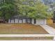 Charming single-story home with a well-manicured lawn, mature trees, and a welcoming front porch at 1514 Pelican St, Longwood, FL 32750