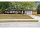 Charming single-story home with a well-maintained lawn and mature trees providing shade at 1514 Pelican St, Longwood, FL 32750